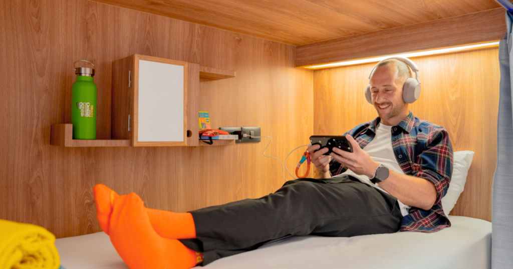 A guest relaxing in a private sleeping pod at Lub d Bangkok Siam